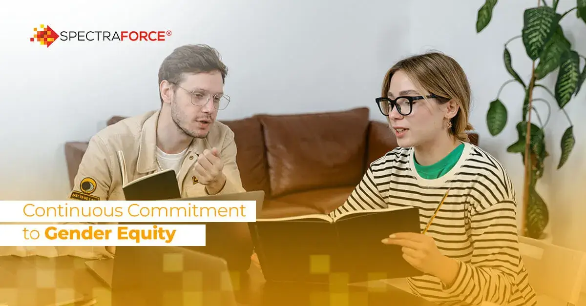 Man and woman in discussion in a cozy setting, focused on promoting gender equity in a business context.
